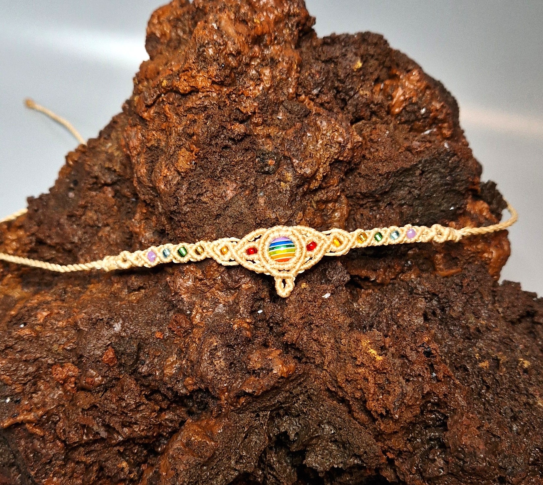 Necklace with colorful beads on a piece of dark brown wood