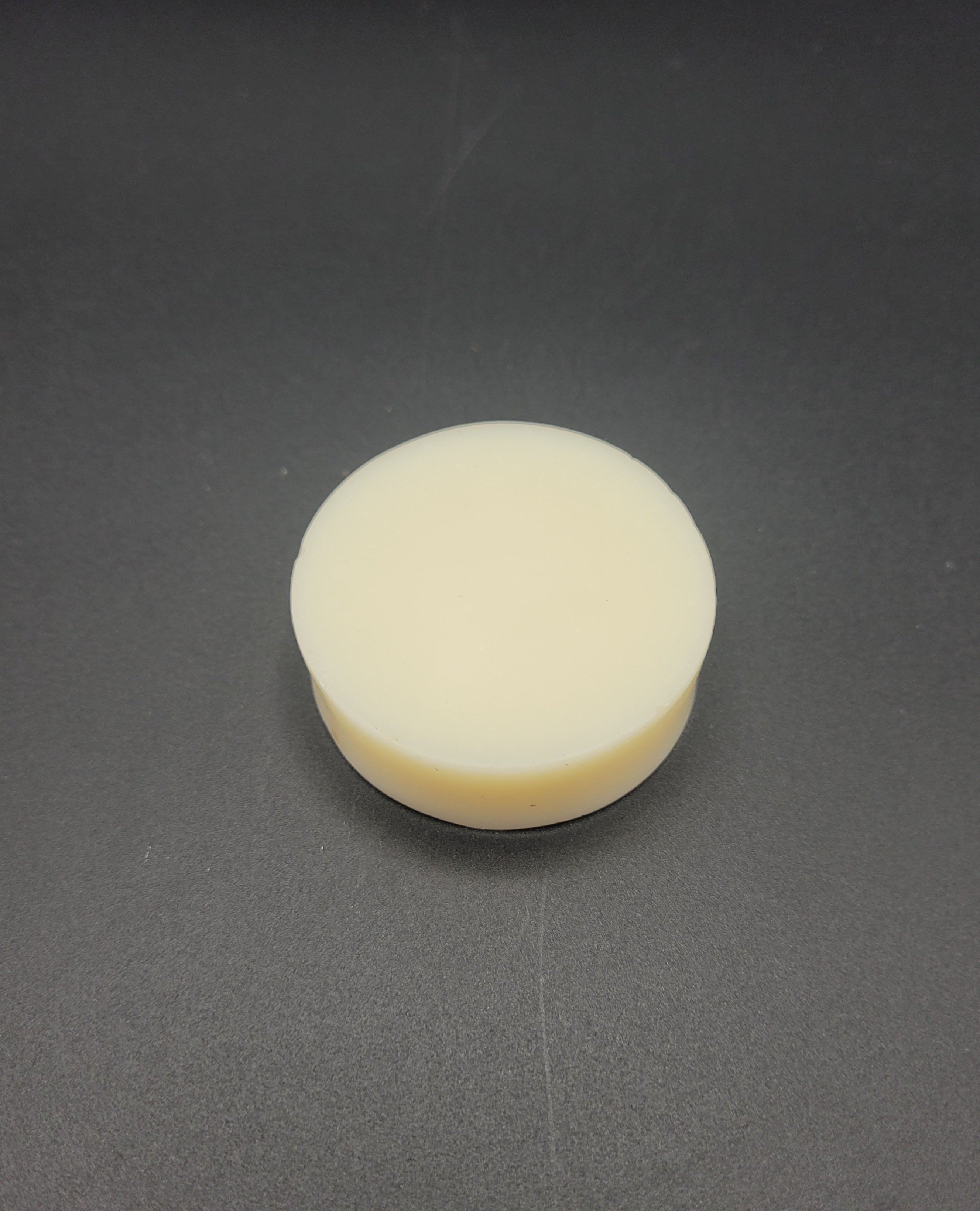 Round white Soap on a gray background