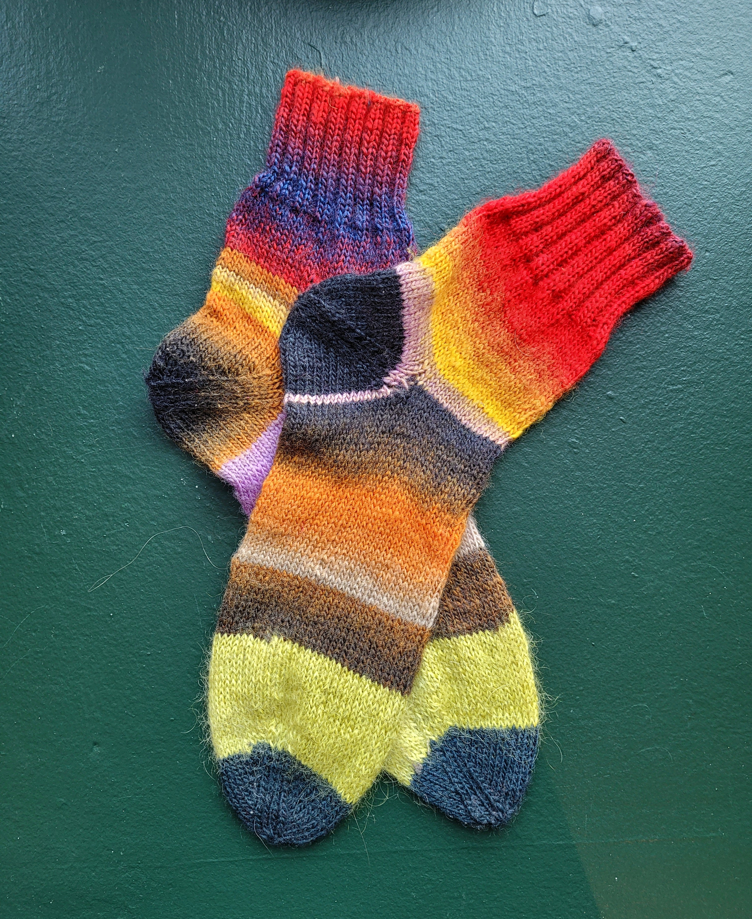 Colorful striped socks on a green surface