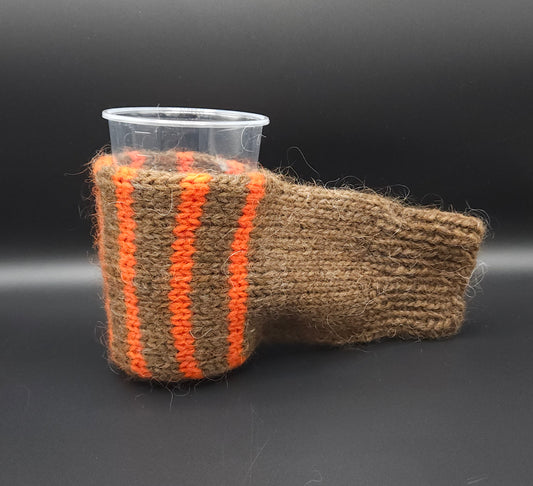 Knitted cup mitten with orange stripes on a black background