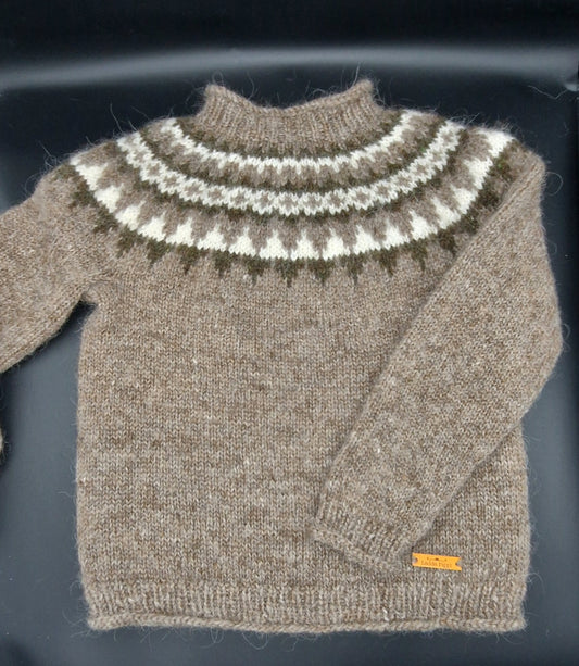 Light brown hand-knit Icelandic wool sweater featuring a traditional Nordic pattern in brown, white, and beige colors on a black surface