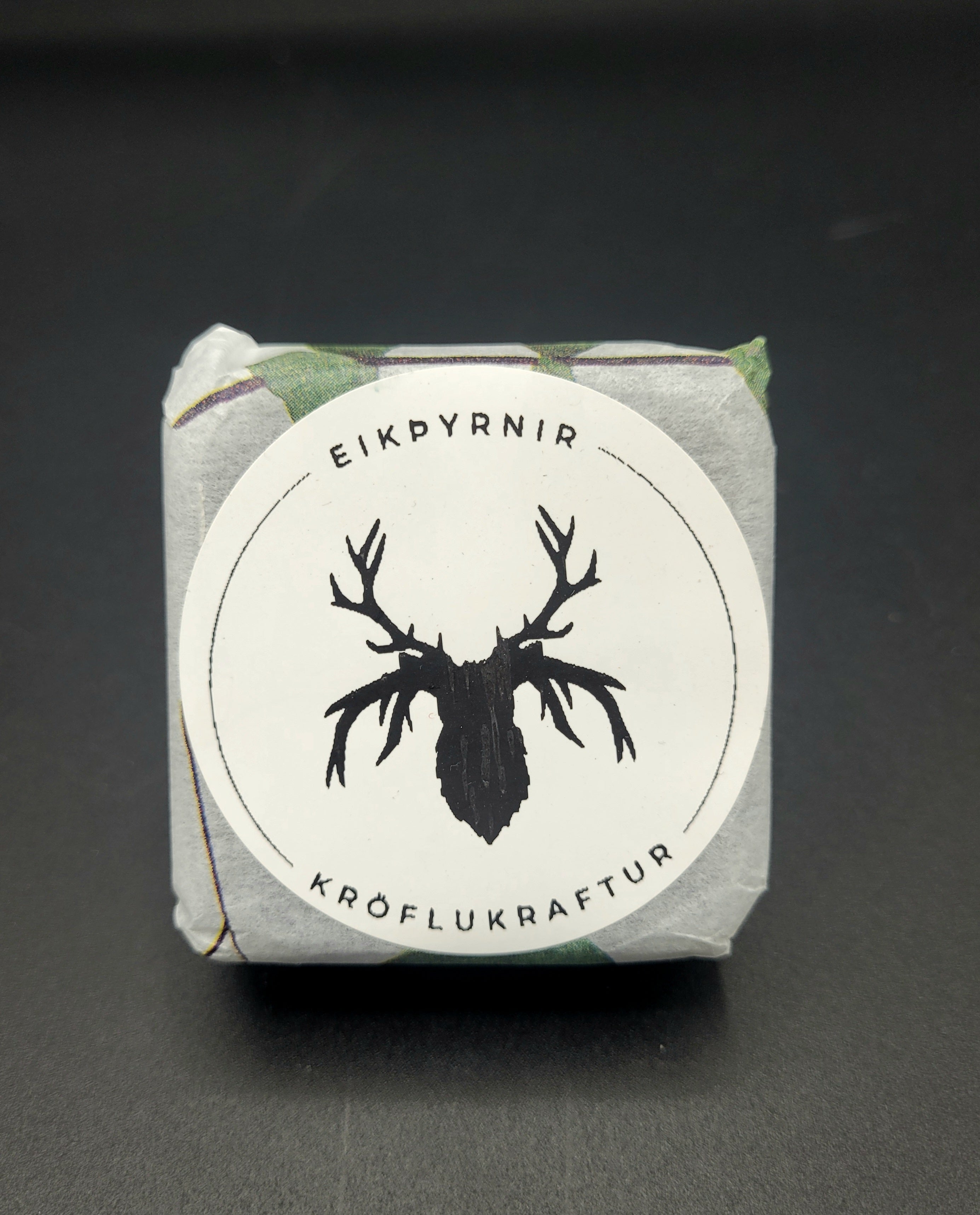 Product packaging with a deer silhouette logo and text on a dark background
