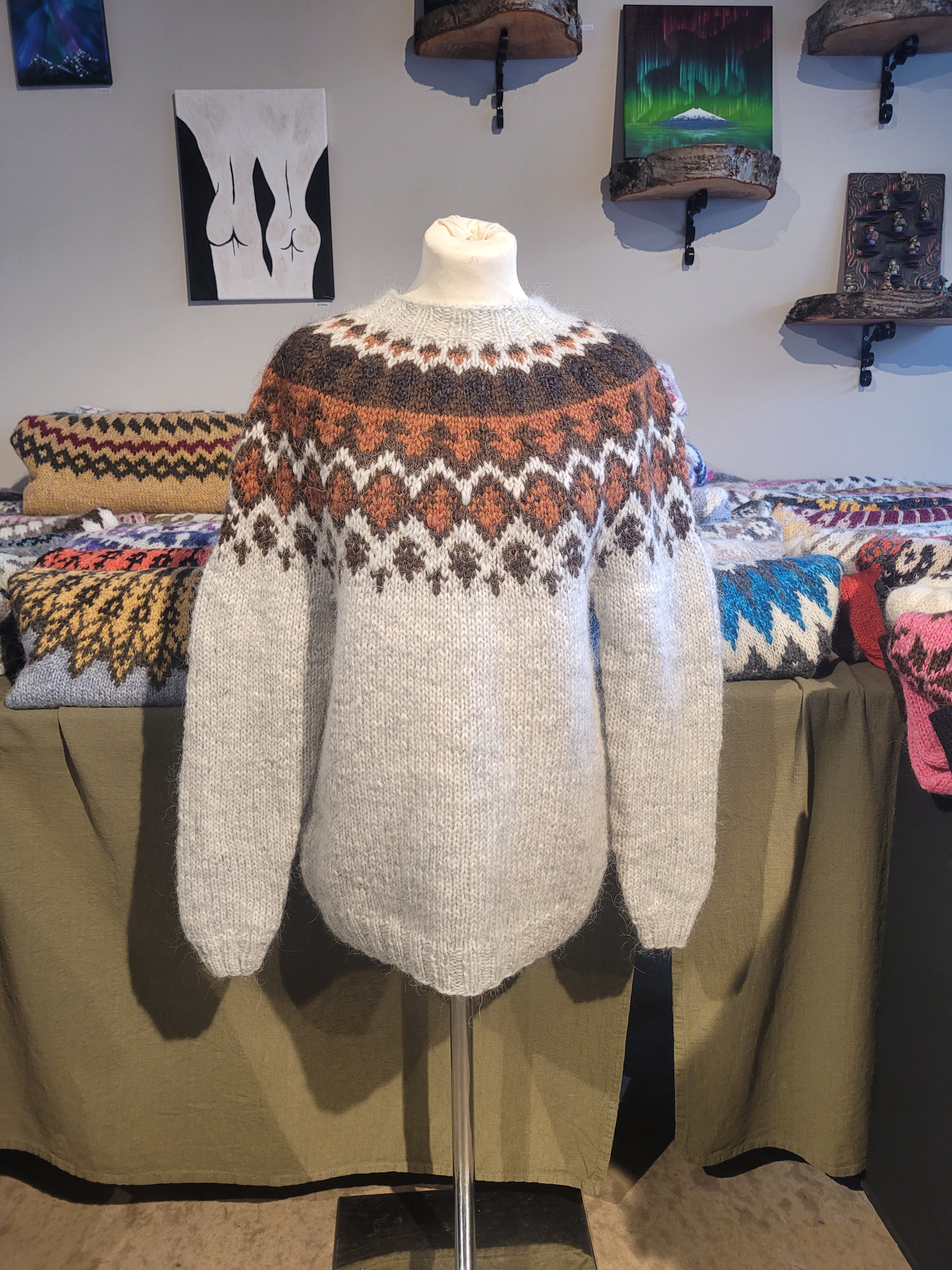 Beige Icelandic wool sweater with brown patterns on a mannequin.