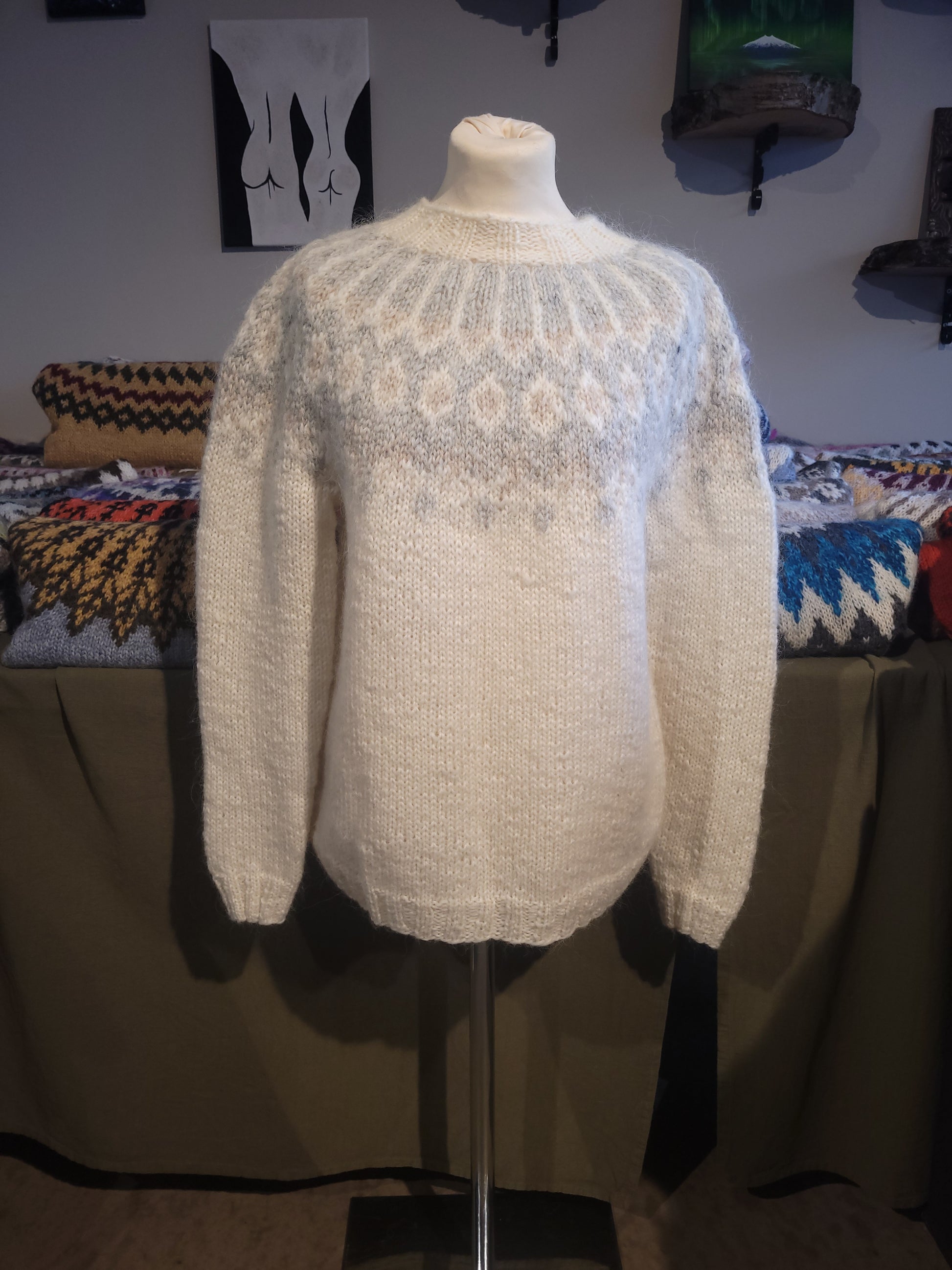 White Icelandic wool sweater with light gray patterns on a mannequin.