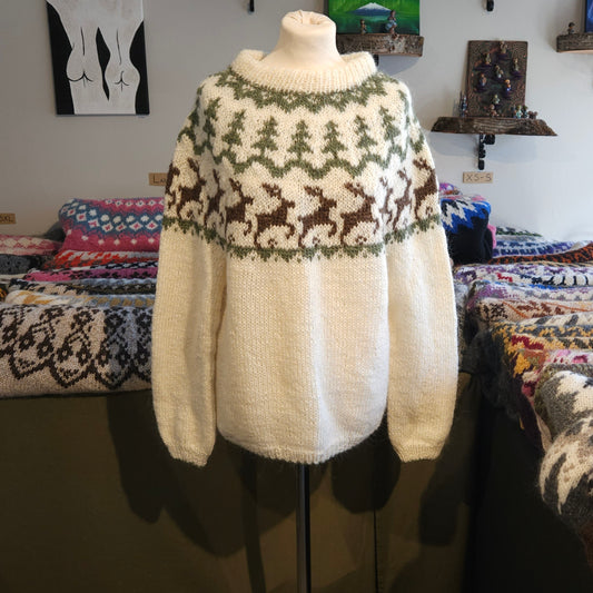 Knitted sweater with reindeer pattern on a mannequin against a colorful background