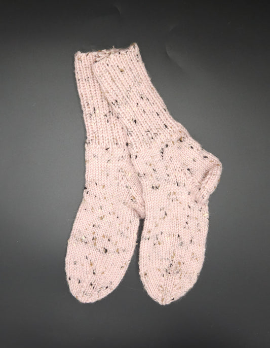 Pair of pink knitted socks on a dark background