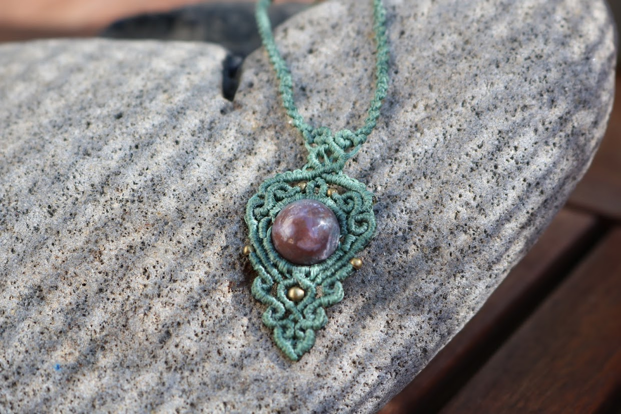 Necklace with a indian agat stone on a stone surface