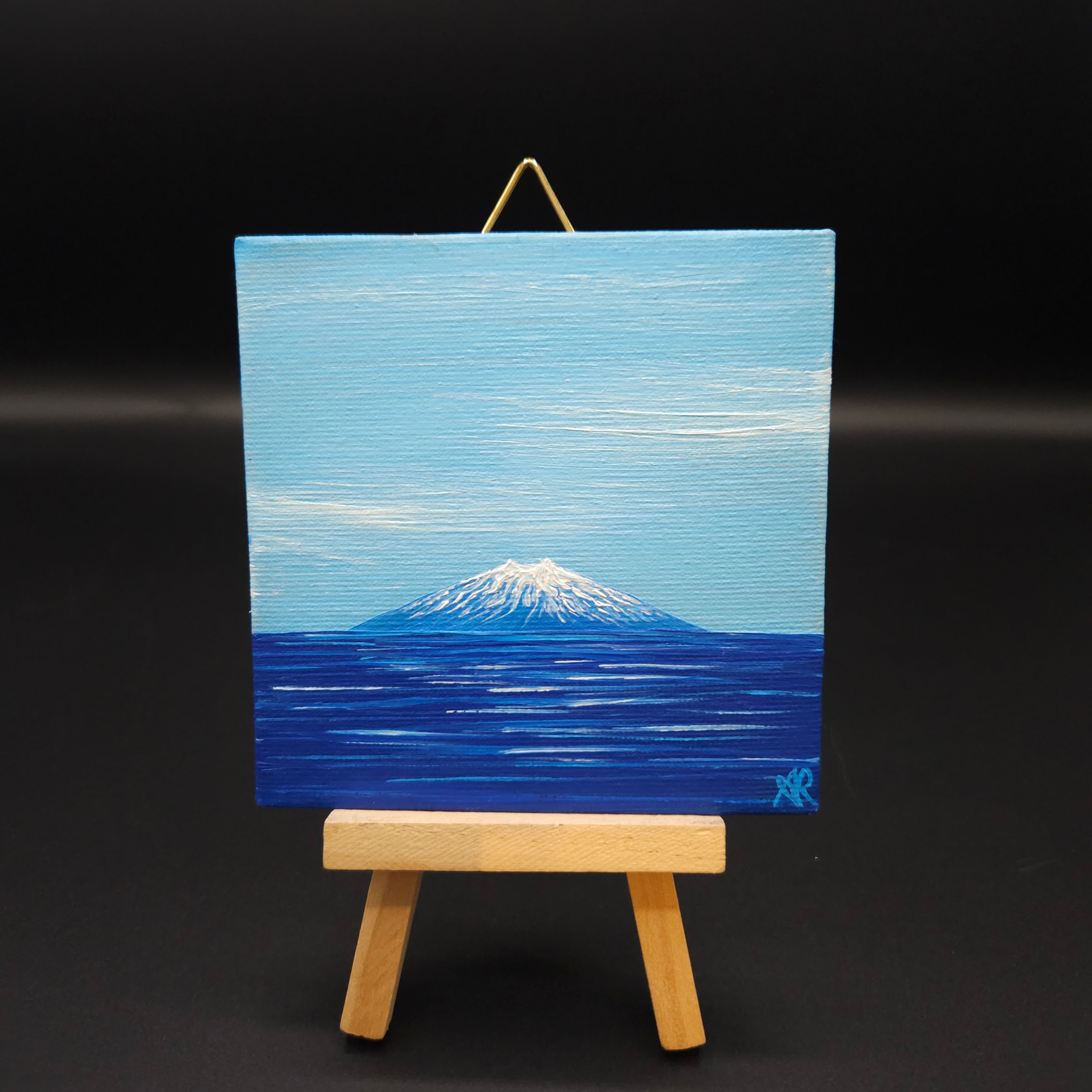 Mountain landscape painting featuring blue colours.