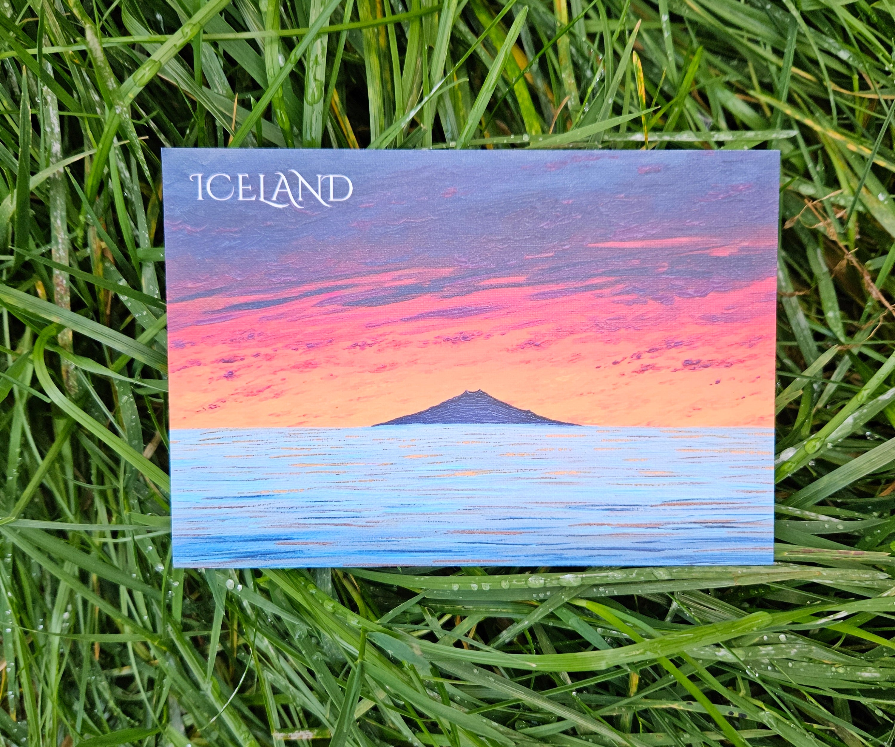 Postcard with a scenic view of Iceland on grass