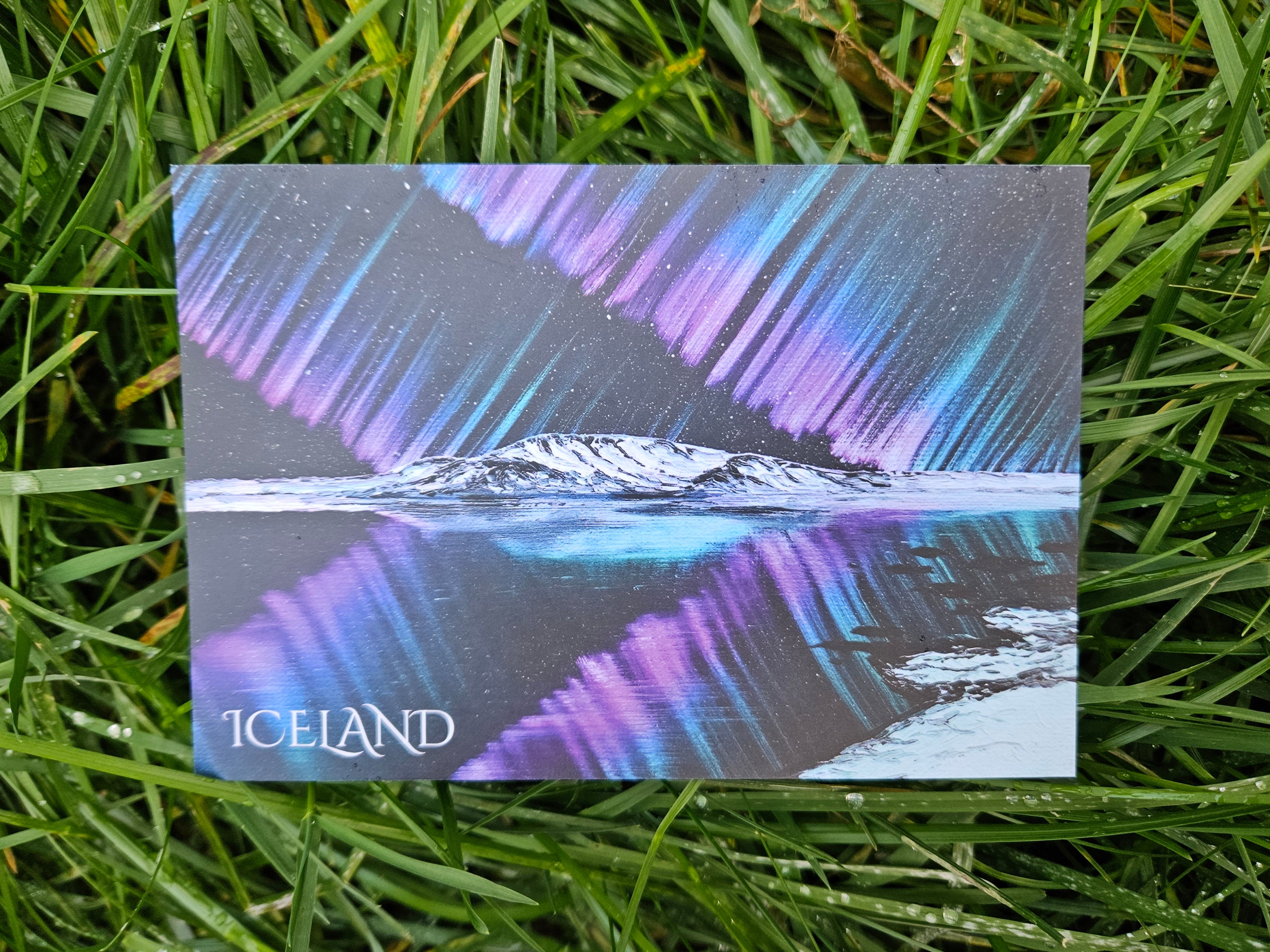 Postcard with Northern Lights design on grass