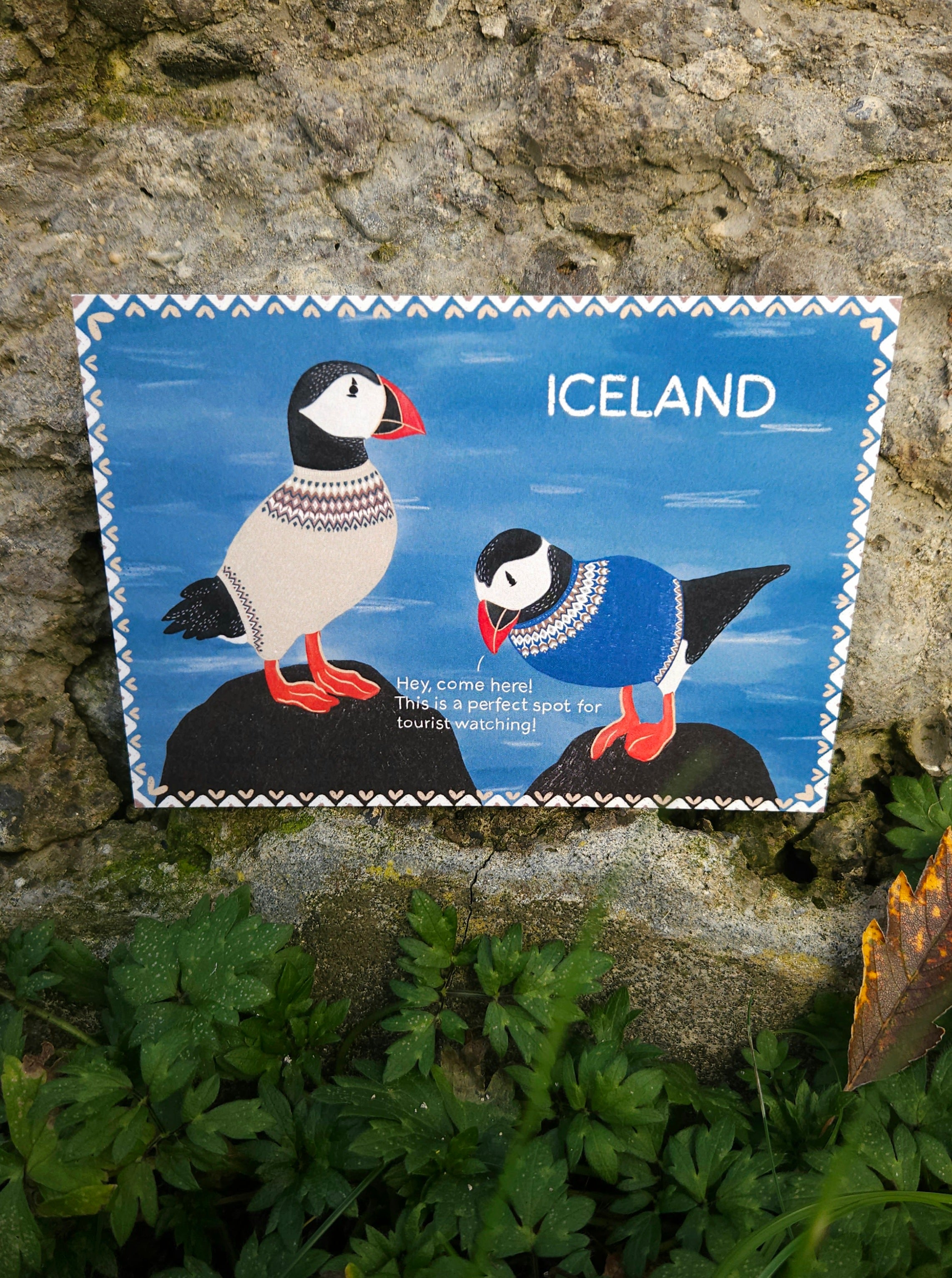 Postcard with puffins on a stone wall