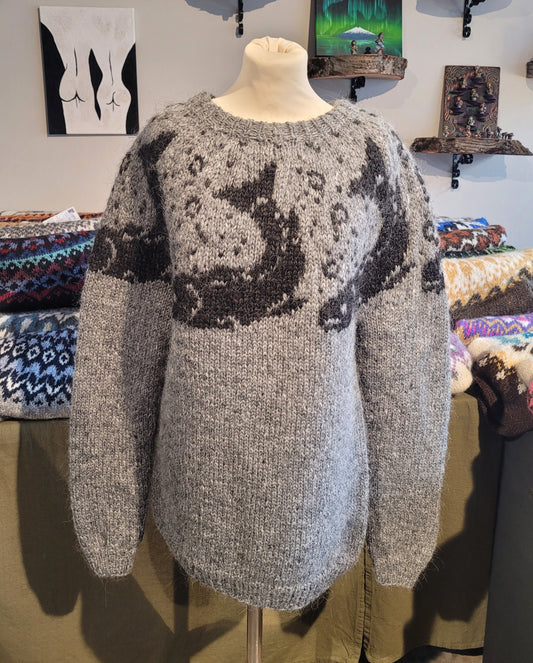 A grey Icelandic wool sweater with a darker shade of a fish pattern.