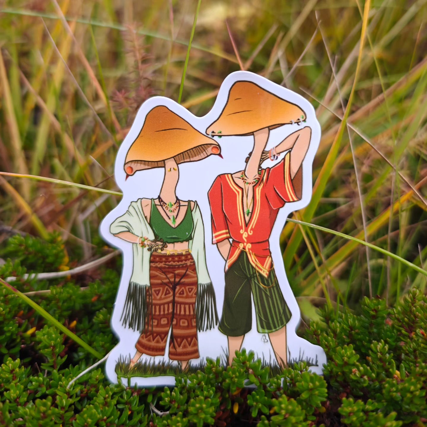 A decorative sticker depicting a cartoonish character with a large mushroom head, placed against a backdrop of green grass.