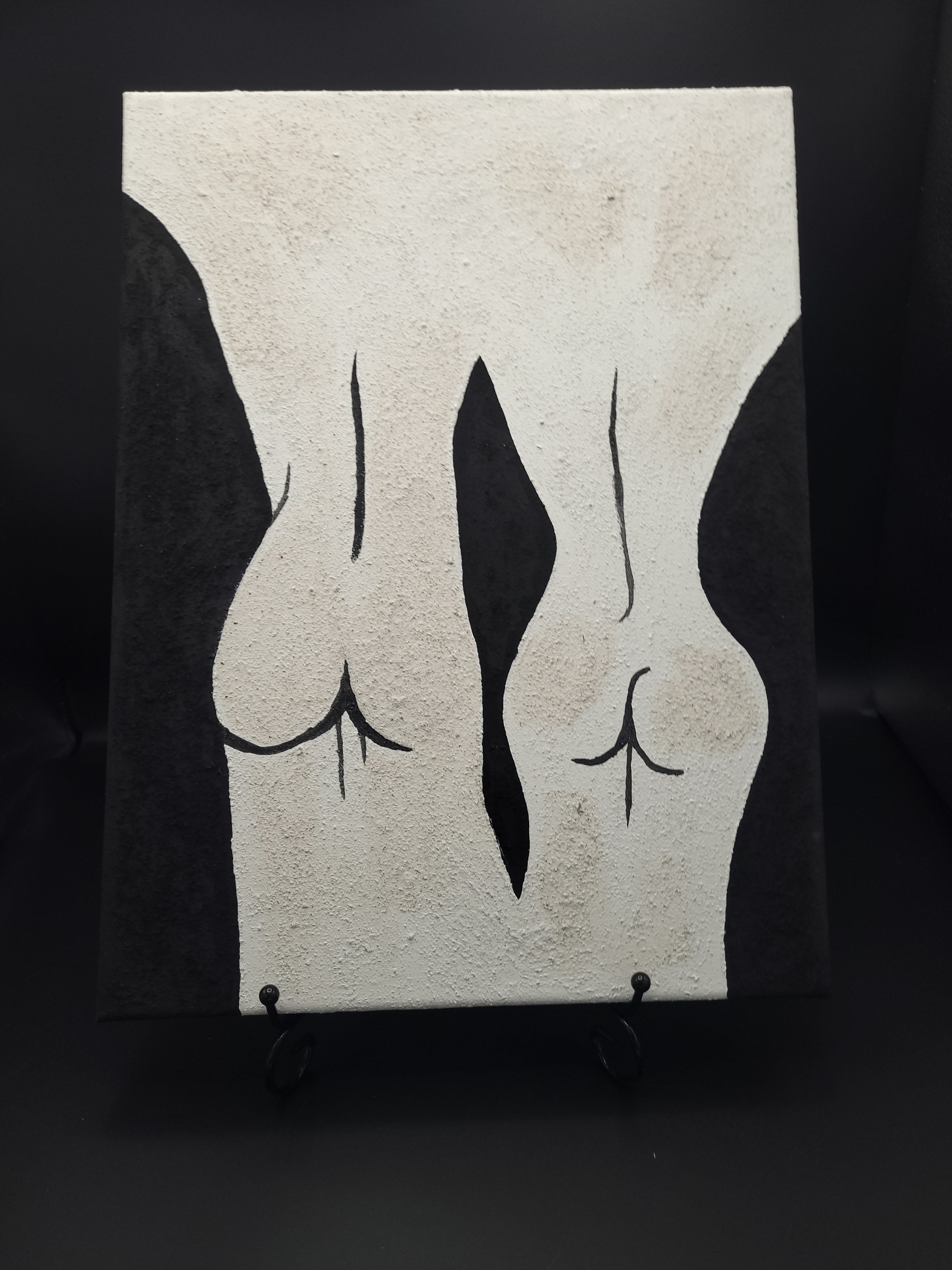 Abstract black and white artwork on a textured surface