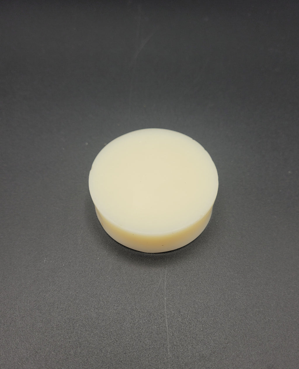 Round white Soap on a gray background