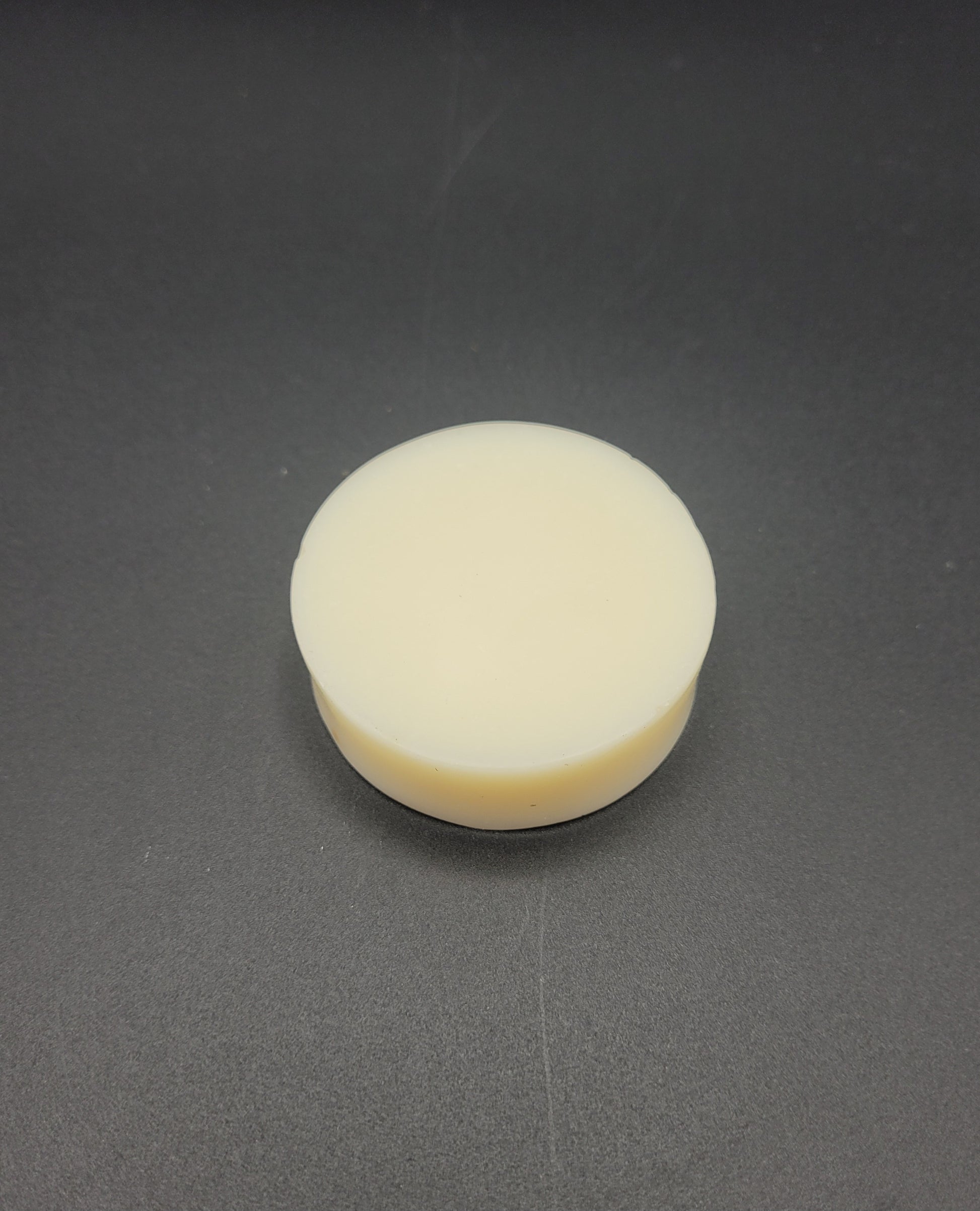 Round white Soap on a gray background