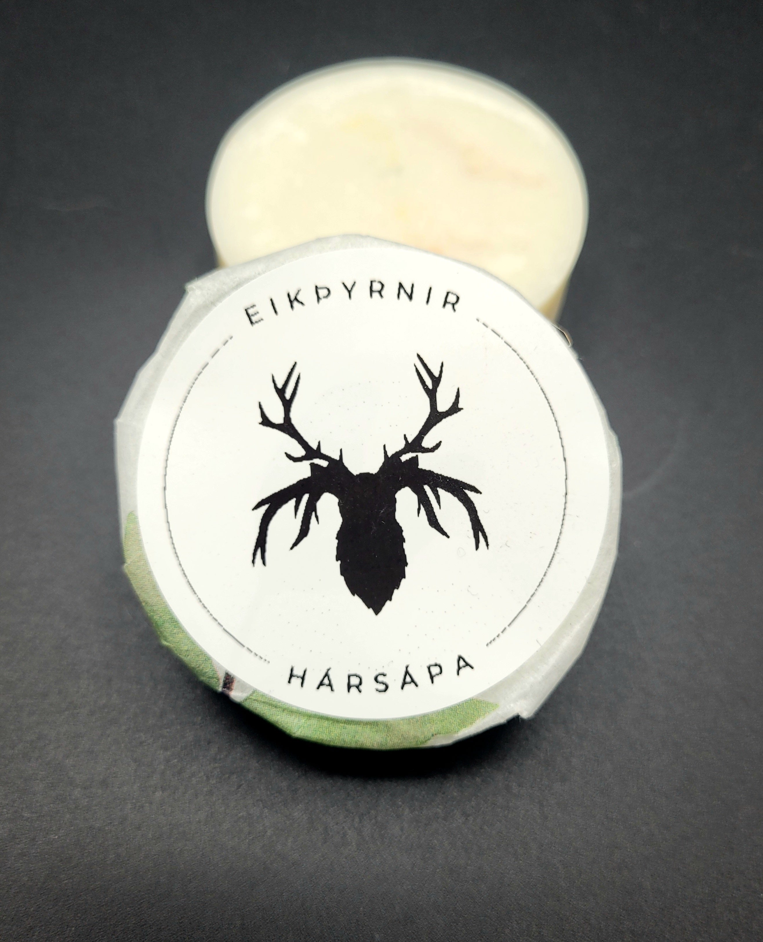 Packaging of Eikþyrnir Hair Soap with a deer silhouette label on a dark background