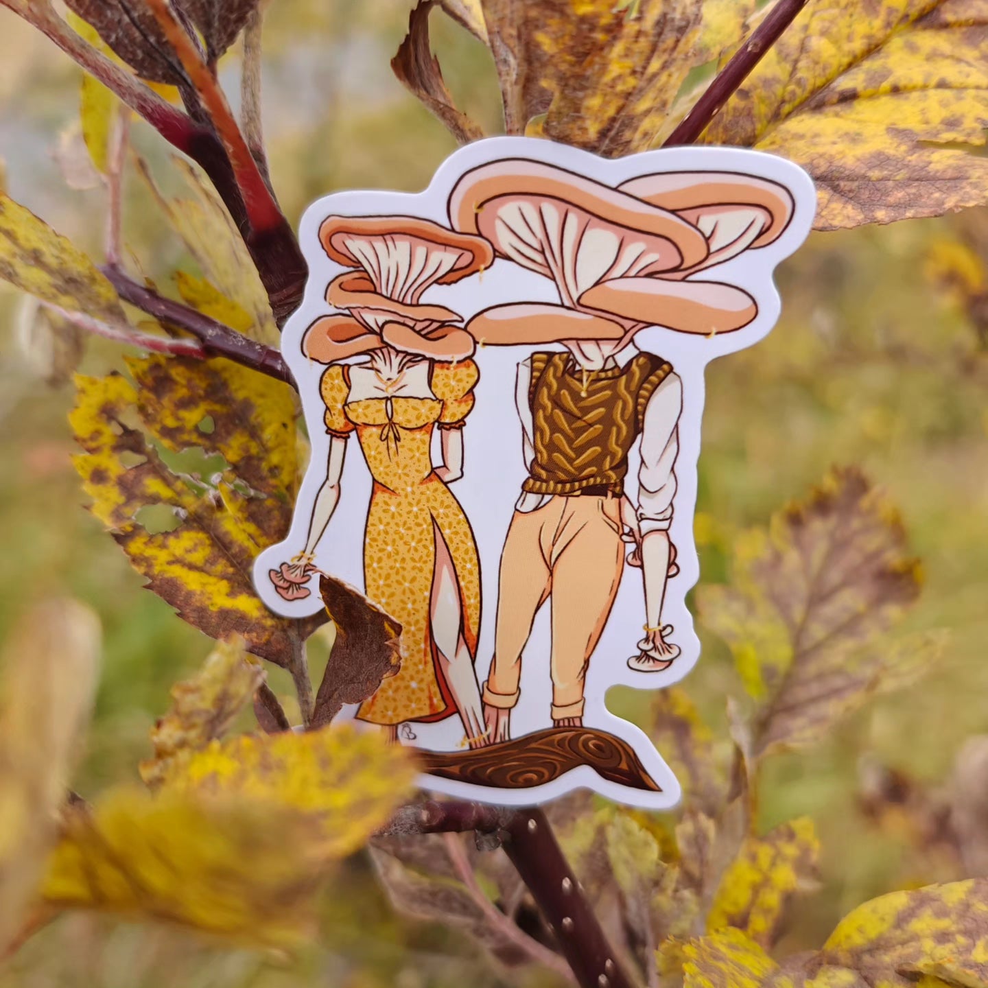 A decorative sticker depicting a cartoonish character with a large mushroom head, placed against a backdrop of yellow leaves.