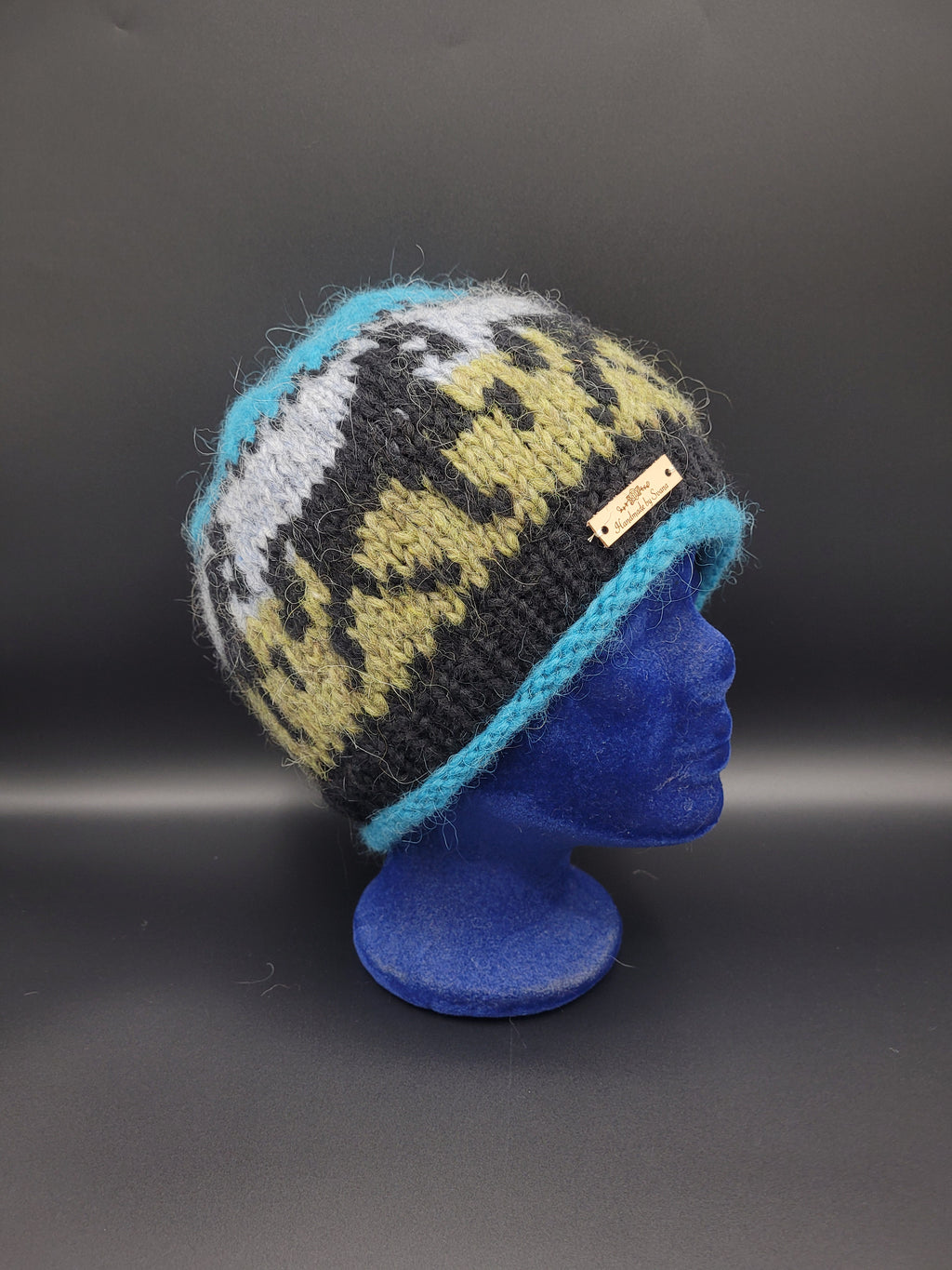 Knitted hat with a horse pattern on a black background