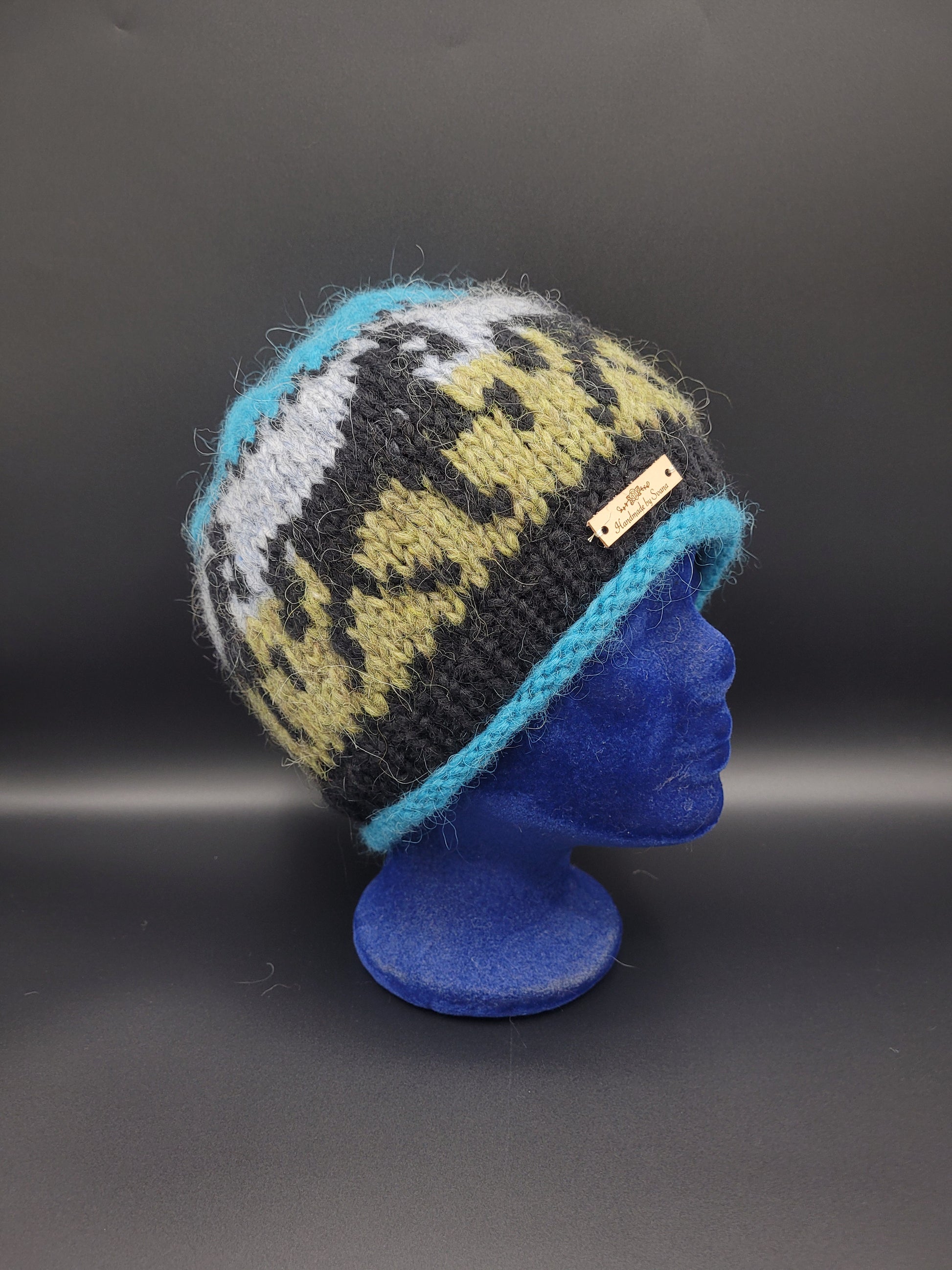 Knitted hat with a horse pattern on a black background