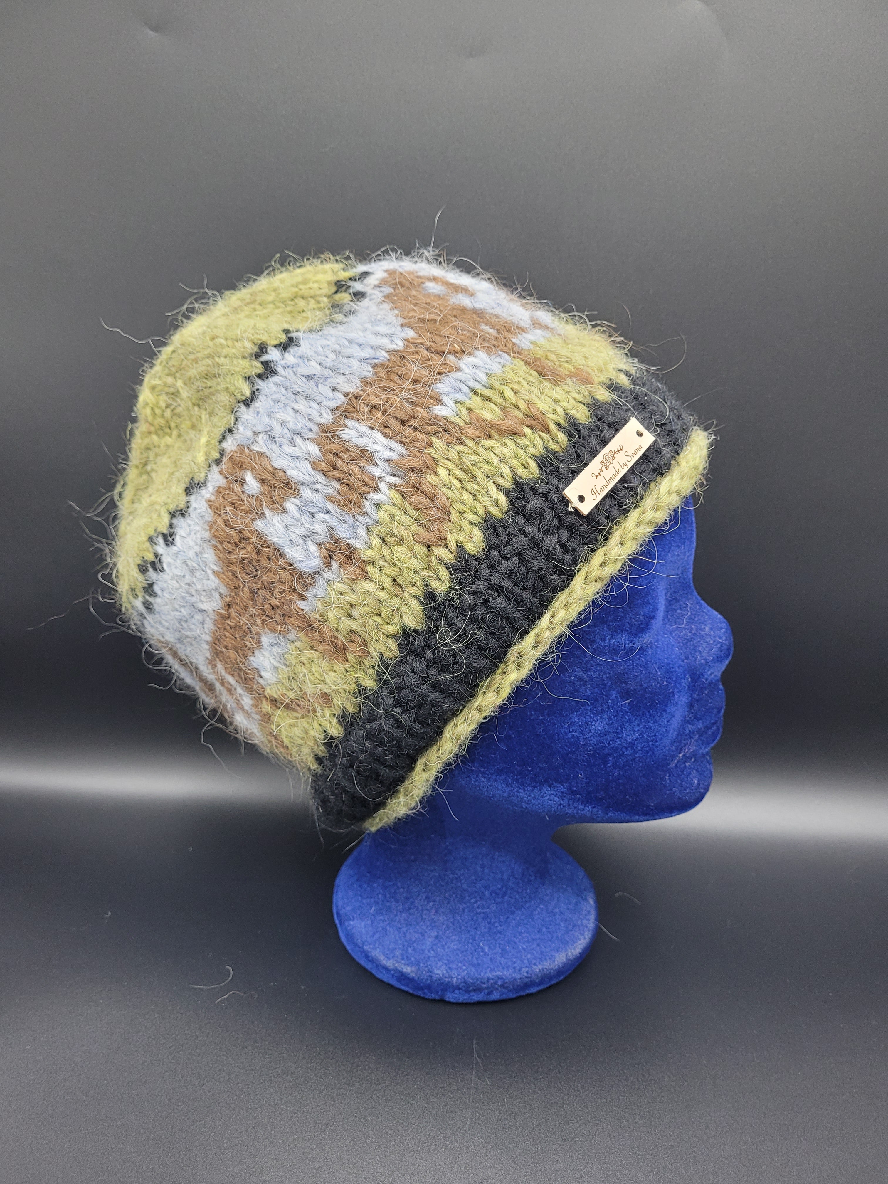Knitted hat with a horse pattern on a black background
